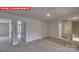 Luminous hallway with doors to bedrooms and bathroom at 8024 Kennesaw Dr, Gastonia, NC 28056