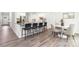Eat-in kitchen with stainless appliances, stone countertops, counter seating, and wood-look floors at 8024 Kennesaw Dr, Gastonia, NC 28056