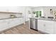 Well-lit kitchen featuring stainless steel appliances, white cabinets, and modern countertops at 8024 Kennesaw Dr, Gastonia, NC 28056