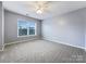 Well-lit bedroom with carpet flooring and ceiling fan at 8331 Burgundy Ridge Dr, Harrisburg, NC 28075