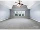Spacious bedroom with ceiling fan and large windows at 8331 Burgundy Ridge Dr, Harrisburg, NC 28075