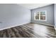 Spacious bedroom with hardwood floors and a large window at 8331 Burgundy Ridge Dr, Harrisburg, NC 28075