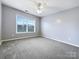 Spacious bedroom with ceiling fan and window at 8331 Burgundy Ridge Dr, Harrisburg, NC 28075