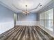 Elegant dining room with hardwood floors and a chandelier at 8331 Burgundy Ridge Dr, Harrisburg, NC 28075