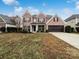 Brick two-story house with a brown door and attached garage at 8331 Burgundy Ridge Dr, Harrisburg, NC 28075