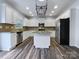 Kitchen with white cabinets, granite countertops, and island at 8331 Burgundy Ridge Dr, Harrisburg, NC 28075