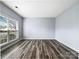 Spare bedroom with hardwood floors and large window at 8331 Burgundy Ridge Dr, Harrisburg, NC 28075
