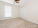 Well lit bedroom with carpet flooring and double door closet at 8820 Rittenhouse Cir, Charlotte, NC 28270