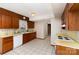 Galley kitchen with wood cabinets, appliances, and tiled floor at 9 Post Oak Pl, Salisbury, NC 28147