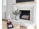 White brick fireplace with wood mantel and decorative vase at 9103 Cameron Wood Dr, Charlotte, NC 28210