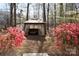 Beautiful backyard gazebo with seating area surrounded by azaleas and mature trees at 1035 Timberlane Dr, Lincolnton, NC 28092