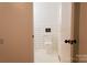 Neutral bathroom featuring a white toilet, tile backsplash, and subtle design elements for a simple look at 1035 Timberlane Dr, Lincolnton, NC 28092