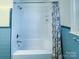 Clean bathroom featuring a shower-tub combination with blue tile accents at 1035 Timberlane Dr, Lincolnton, NC 28092