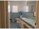 Classic bathroom features blue tile, updated vanity, and ample lighting at 1035 Timberlane Dr, Lincolnton, NC 28092
