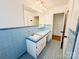 Bathroom featuring blue tile, a vintage vanity and sink, and a mirror at 1035 Timberlane Dr, Lincolnton, NC 28092