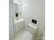 Clean bathroom featuring white tiled walls, vanity, and toilet in a functional and minimalist space at 1035 Timberlane Dr, Lincolnton, NC 28092