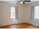 Sunny bedroom featuring hardwood floors, two windows, and neutral paint at 1035 Timberlane Dr, Lincolnton, NC 28092