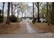 A view of the home from the street, highlighting the long driveway and front facade at 1035 Timberlane Dr, Lincolnton, NC 28092