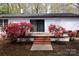 View of the back of the home highlighting the brick steps and flower garden; an entertaining space at 1035 Timberlane Dr, Lincolnton, NC 28092