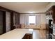 A view of the kitchen, showcasing its brick wall, wooden cabinets, and window at 1035 Timberlane Dr, Lincolnton, NC 28092