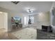 Bonus room with hardwood floors, TV, and sofa at 105 Fleishhacker Pl, Mooresville, NC 28117