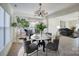 Dining room with marble table and gray chairs, open to kitchen at 105 Fleishhacker Pl, Mooresville, NC 28117
