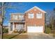 Two-story brick home with attached garage and front porch at 105 Fleishhacker Pl, Mooresville, NC 28117