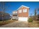 Two-story brick home with attached garage and front porch at 105 Fleishhacker Pl, Mooresville, NC 28117