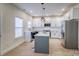 Modern kitchen with white cabinets, quartz countertops, and stainless steel appliances at 105 Fleishhacker Pl, Mooresville, NC 28117
