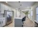 Modern kitchen with island, white cabinets, and stainless steel appliances at 105 Fleishhacker Pl, Mooresville, NC 28117
