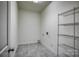 Laundry room with wire shelving and grey tile flooring at 105 Fleishhacker Pl, Mooresville, NC 28117