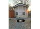 Tan mobile home with three windows and a black address marker at 145 Arrowood Trl # 61F, Mount Gilead, NC 27306