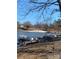 Sandy beach, wooden docks, and pontoon boats on lake at 145 Arrowood Trl # 61F, Mount Gilead, NC 27306