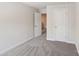 Cozy bedroom boasts soft carpeting, neutral paint, and two doors at 1604 Village Grove Ln, Monroe, NC 28110