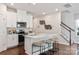 Modern kitchen featuring white cabinets, a central island, and stainless steel appliances at 1604 Village Grove Ln, Monroe, NC 28110