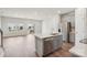 Kitchen island with stainless steel appliances and an open view of the living area at 1604 Village Grove Ln, Monroe, NC 28110