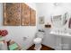 Clean and bright bathroom with pedestal sink and updated toilet at 235 Goldenrod Cir, Salisbury, NC 28147