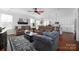 Open living room with brown reclining sofas and hardwood floors at 235 Goldenrod Cir, Salisbury, NC 28147
