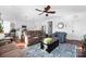 Relaxing living room with comfy seating, ceiling fan, and hardwood floors at 235 Goldenrod Cir, Salisbury, NC 28147