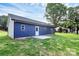 Exterior view of the home showing the backyard, manicured lawn, concrete patio and blue siding at 2365 28Th Ne St, Hickory, NC 28601