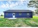 Backyard view of a home featuring a well-kept lawn, patio and blue siding at 2365 28Th Ne St, Hickory, NC 28601