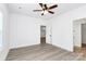 Well-lit bedroom boasts wood-look floors, a ceiling fan, and an adjacent closet with shelves at 2365 28Th Ne St, Hickory, NC 28601