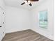 This bedroom features modern flooring, a ceiling fan, and natural light from a window at 2365 28Th Ne St, Hickory, NC 28601