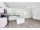 Open-concept kitchen boasts white cabinets, an island, and modern finishes at 2365 28Th Ne St, Hickory, NC 28601