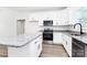 Updated kitchen with white cabinets, granite counters, stainless appliances, and an island with a breakfast bar at 2365 28Th Ne St, Hickory, NC 28601