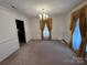 Bright dining room with chandelier and wainscoting at 319 N Peterson St, Stanley, NC 28164