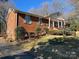 Brick ranch house with a covered porch and a landscaped yard at 319 N Peterson St, Stanley, NC 28164