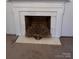 Fireplace with marble surround and brass screen at 319 N Peterson St, Stanley, NC 28164