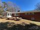 Brick house back view with sunroom and patio at 319 N Peterson St, Stanley, NC 28164