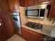 Stainless steel appliances built into wood cabinets at 319 N Peterson St, Stanley, NC 28164